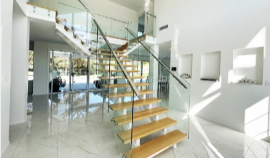 What are the advantages of using glass handrails for staircases?